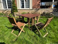 Full patio set on lawn showing table and four chairs