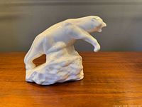 Left side view of white ceramic bear figurine