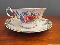 Side view of Paragon tea cup on saucer showing floral bouquet and gold filigree
