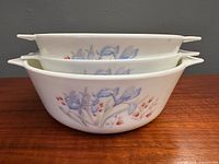 Stacked view of three Pyrex Blue Iris casseroles showcasing pattern and sizes