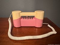 Front view of assembled two-tone telephone showing keypad and cord