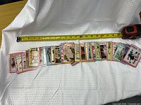 All 22 cards laid out with tape measure for scale