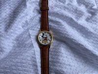 Front view showing dial, character graphic, case and strap
