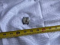 Front view of watch head with tape measure for scale