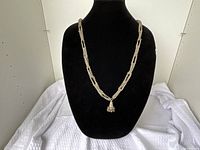 Necklace displayed on bust showing overall design and pendant