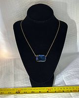 Full view of necklace on bust showing pendant and chain