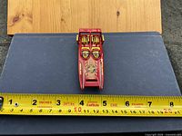 Top view showing overall design, color, graphics and engine detail with ruler for scale