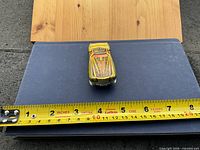 Top view of car on notebook with tape measure showing length