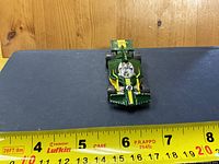Front view of green/yellow Hot Wheels formula car showing number 8 and length scale