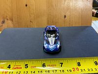 Top view showing blue-purple flame graphics and open cockpit