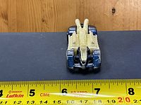 Top view of Hot Wheels Krazy 8s showing blue body and yellow engine, ruler for scale