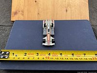Top view showing overall shape, color, markings and length with tape measure