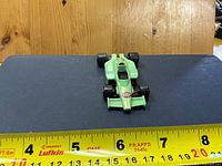 Top view of green Majorette F1 car showing overall wear