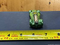 Top view showing green body, yellow canopy, chrome engine