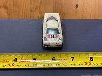 Front view of toy car showing hood decal and length measurement