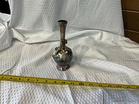 Full view of vase with tape measure indicating height ~7.5 in