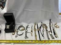 Group shot of all watches with measuring tape for scale