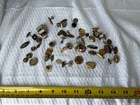 full lot of mixed cufflinks and studs with measuring tape for scale