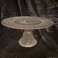 Oblique view of entire glass cake stand showing plate and pedestal