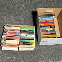 Two stacks of Sherlock Holmes paperbacks, overall quantity and condition visible