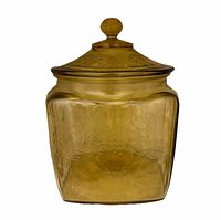 Frontal view of amber glass cookie jar with lid showing shape and color