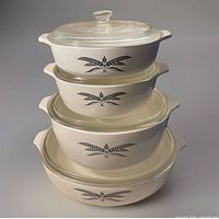 Stacked view showing four casserole bases and lids, Black Wheat pattern visible