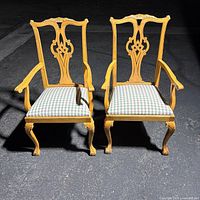 Front view of both birch Chippendale style armchairs with plaid seats