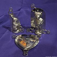 front view of rabbit, bear and heart chocolate molds with clips attached