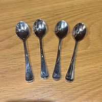 Front view of four Godinger dessert spoons
