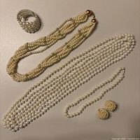 Group shot showing all six necklaces, bracelet, and clip-on earrings