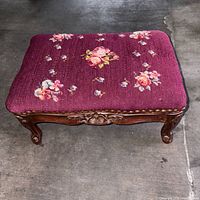 Top view showing burgundy floral needlepoint upholstery