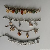 Group shot of all four charm bracelets laid out