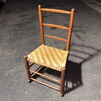 Front view showing ladder back, rush seat