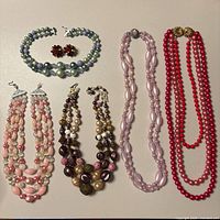 All five necklaces and earrings arranged for overview