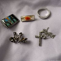 All six sterling items laid out on fabric
