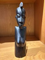 Front view of carved wooden female bust