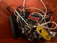 Bin showing mixed extension cords, power bar, Digiflex cable