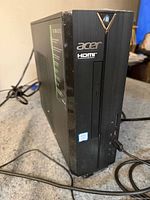 Front view of Acer Aspire XC-885 tower showing optical drive, ports and branding