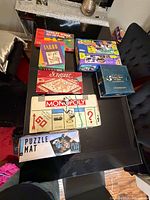 Overview of all game boxes and puzzle mat on table