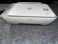 Front and top view of HP DeskJet 2855e printer showing overall condition and Instant Ink sticker
