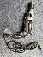 Full view of hammer drill showing body, chuck and cord