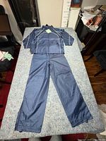 Tracksuit jacket and pants laid out full view