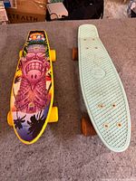 Top view of both skateboards showing deck colours and graphics