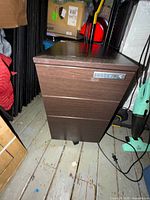 front view of cabinet showing three drawers and lock