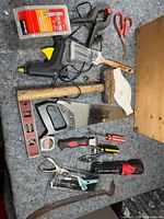 Assorted hand tools laid out on surface