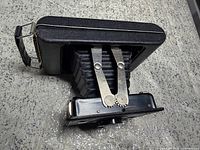 Camera folded open showing bellows and struts
