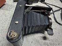 Kodak No. 2A camera extended showing bellows, film advance key and secondary camera in background
