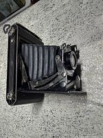 Left side profile showing bellows extended and metal struts