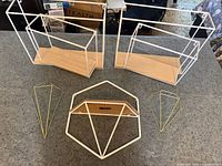 Overview of all five geometric wall décor pieces on countertop