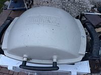 Top view showing Weber logo on titanium lid and both side handles